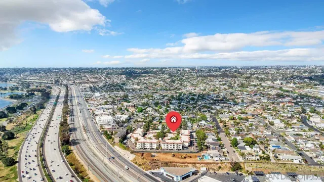 an aerial view of a residential houses with city view
