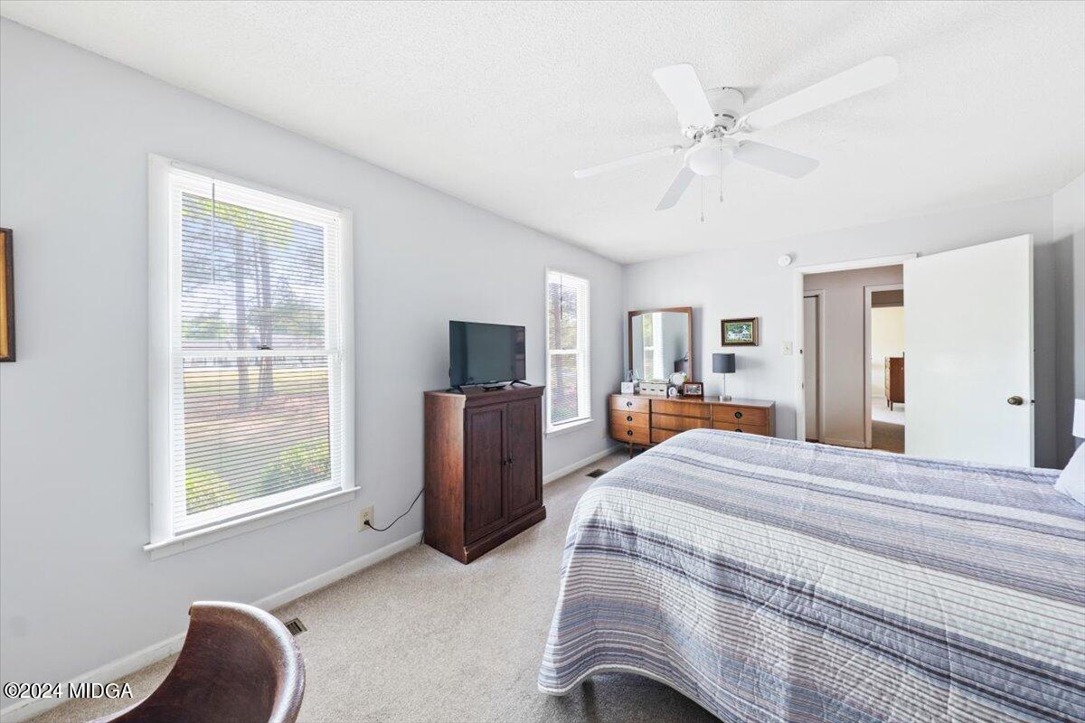 6271 Stapleton Road Macon, GA 31206 - Photo 14 of 41 a bedroom with a large bed and a window