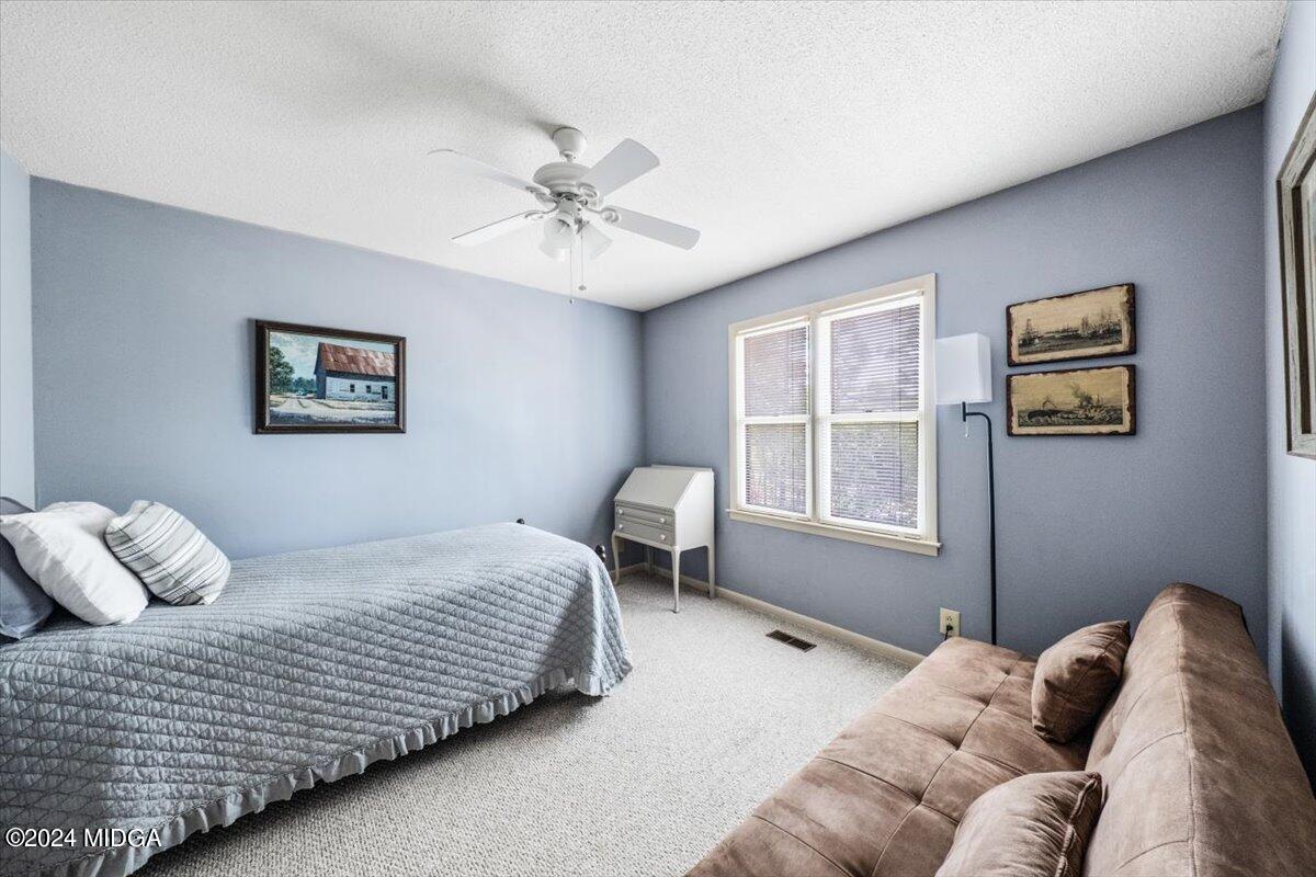 6271 Stapleton Road Macon, GA 31206 - Photo 19 of 41 a bedroom with a large bed and a window