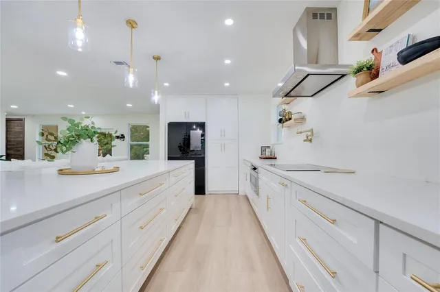 a large kitchen with a large counter top appliances and cabinets
