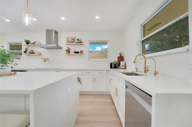 a kitchen with kitchen island white cabinets and sink