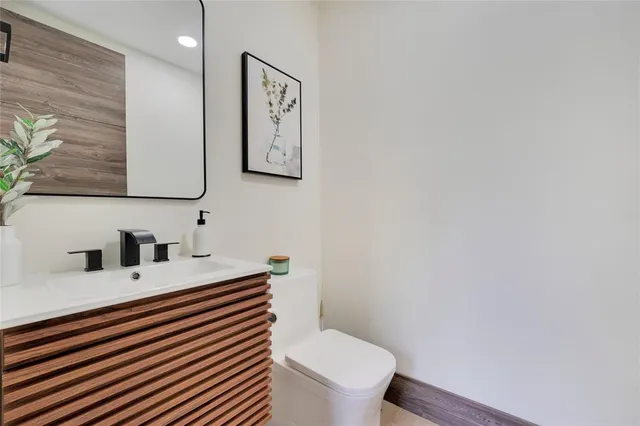 a bathroom with a sink a toilet and mirror