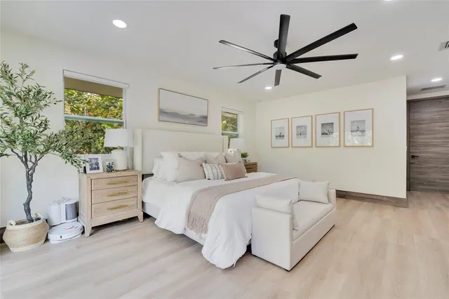 a bedroom with a bed and a potted plant
