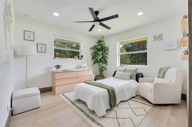 a spacious bedroom with a bed and a couch