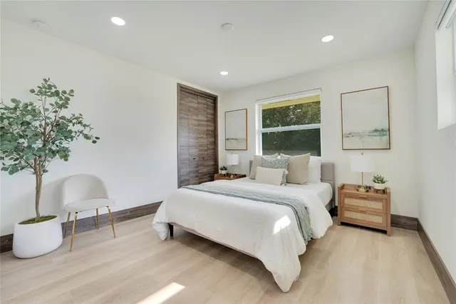 a bedroom with bed and a potted plant