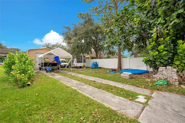a view of a house with a yard and a garage