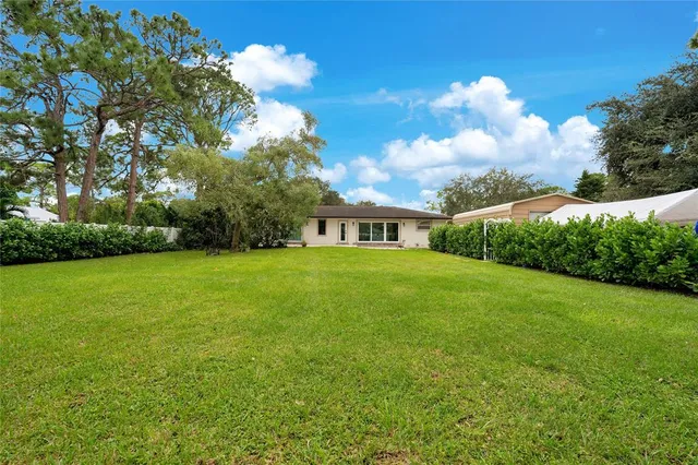 a view of a house with yard and green space