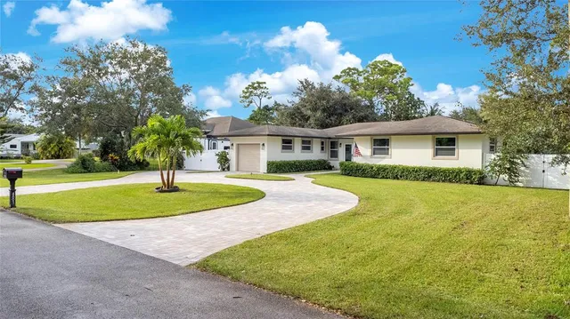 a view of house with outdoor space and garden