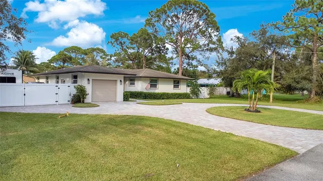 a view of a house with a swimming pool and a yard