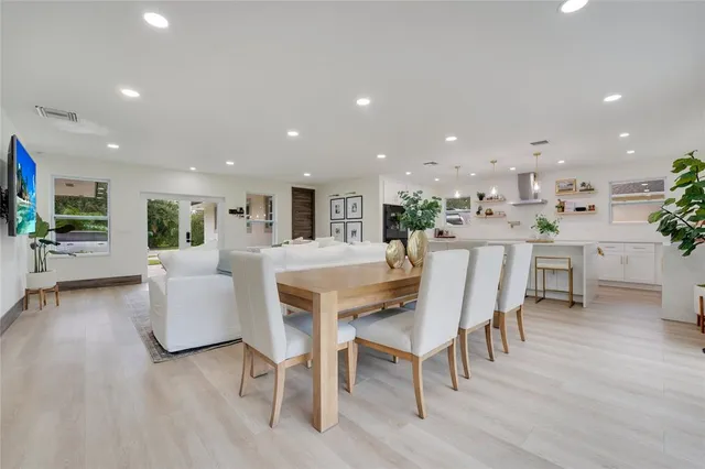 a dining room with furniture and wooden floor