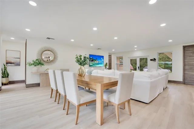 a living room with furniture a wooden floor and a clock