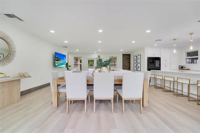 a large kitchen with a table and chairs in it