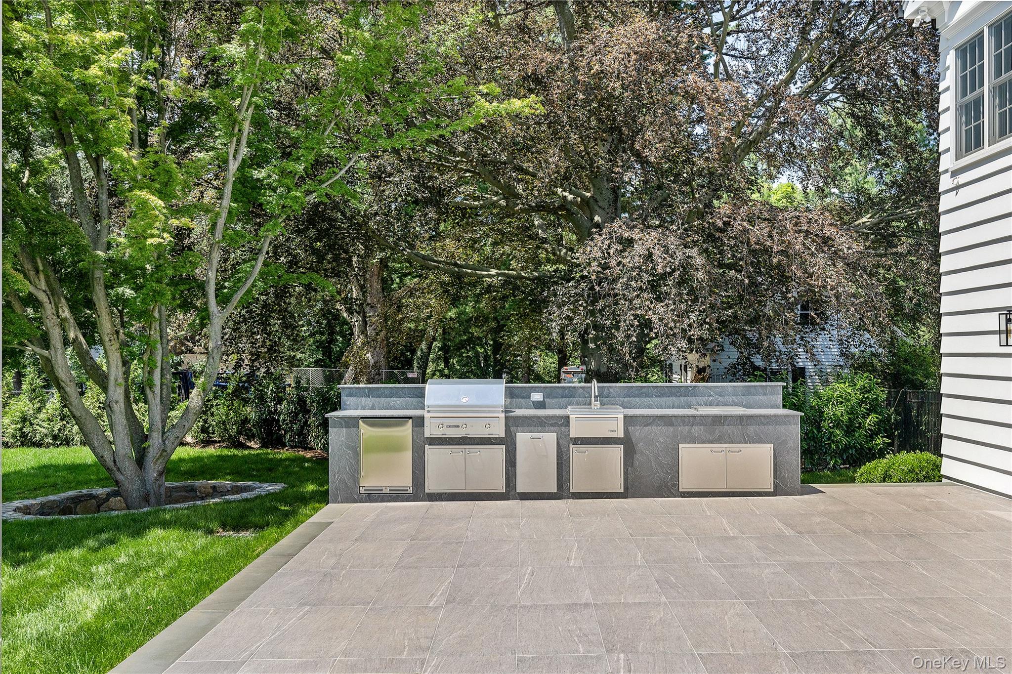 42 Mamaroneck Road Scarsdale, NY 10583 - Photo 5 of 47 Resort-inspired outdoor amenities include expansive patios, and beautifully designed spaces for relaxing or entertaining including this fully equipped outdoor kitchen.