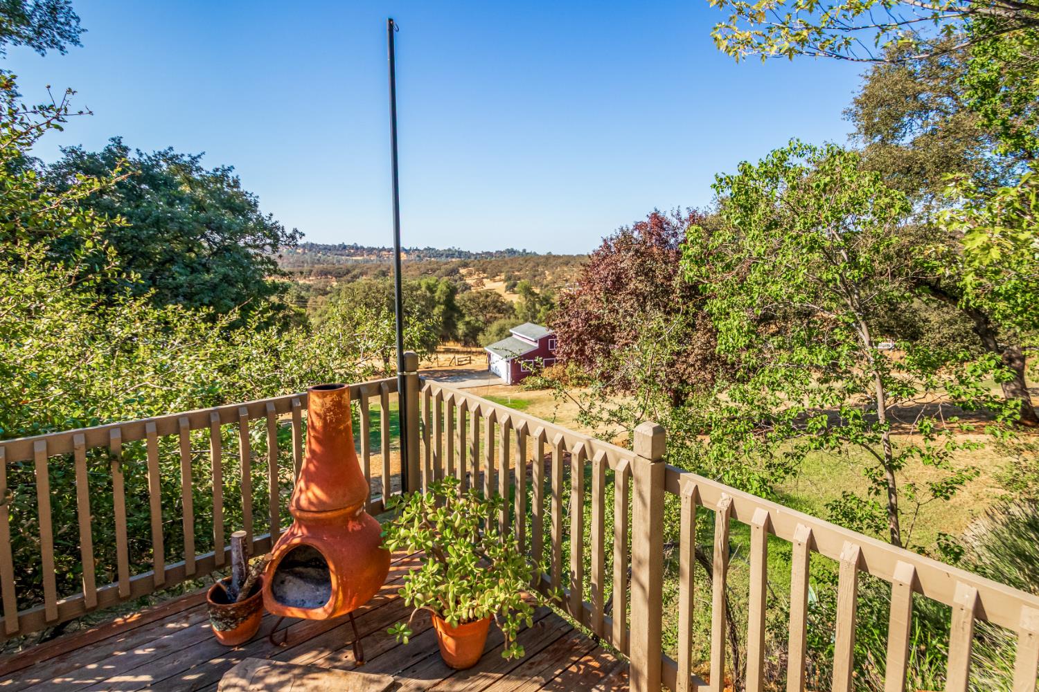 9290 Cramer Road Auburn, CA 95602 - Photo 9 of 67 a view of a deck with a large window and wooden fence