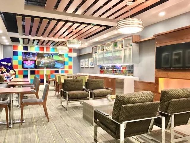 a living room with furniture a flat screen tv and kitchen view