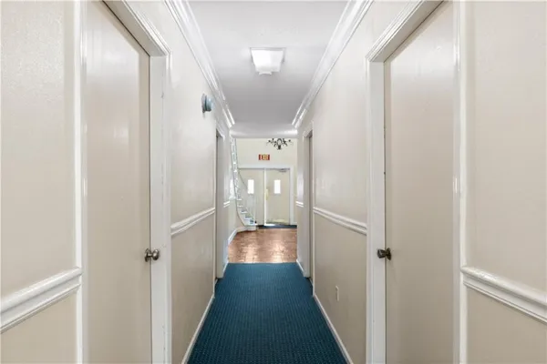 a view of hallway with wooden floor