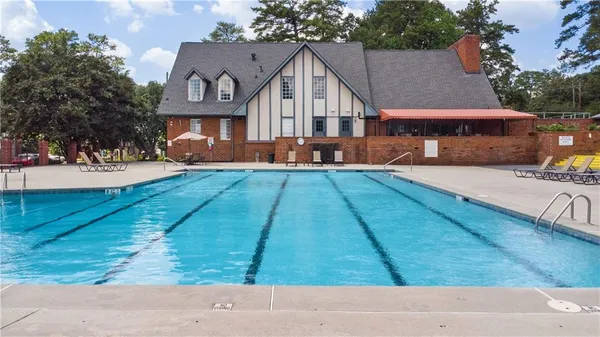 a view of a house with pool and yard