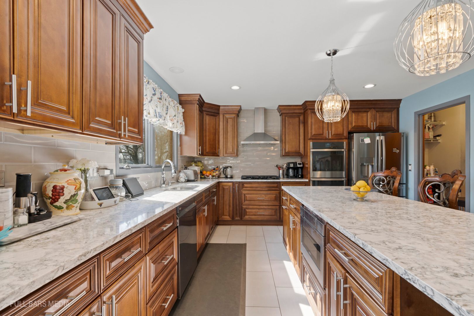 535 Denoyer Trail Wheeling, IL 60090 - Photo 15 of 45 a kitchen with stainless steel appliances granite countertop sink stove and cabinets