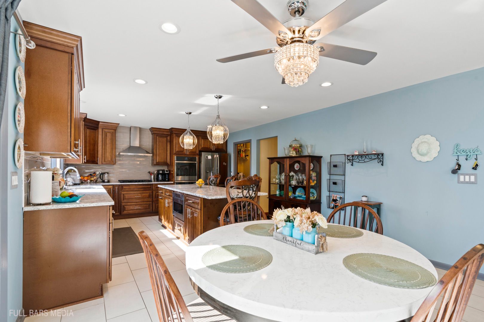 535 Denoyer Trail Wheeling, IL 60090 - Photo 16 of 45 a dining room with stainless steel appliances kitchen island granite countertop a dining table and chairs with a dining table