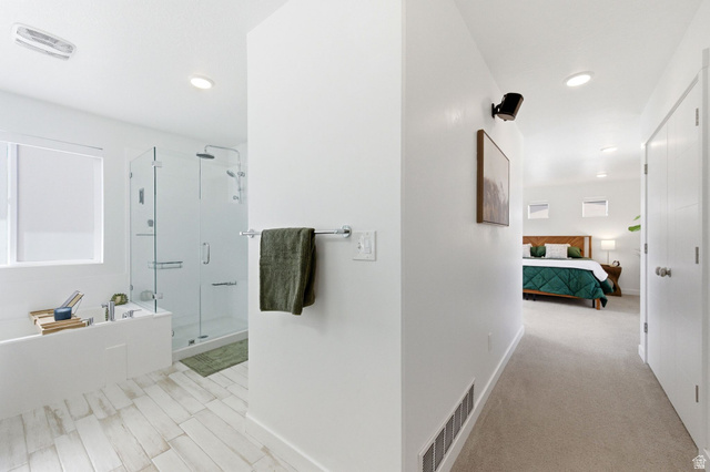 4595 College Ridge Court Millcreek, UT 84117 - Photo 19 of 57 Primary suite with en suite bathroom, soaker tub, euro glass shower, and walk in closet.