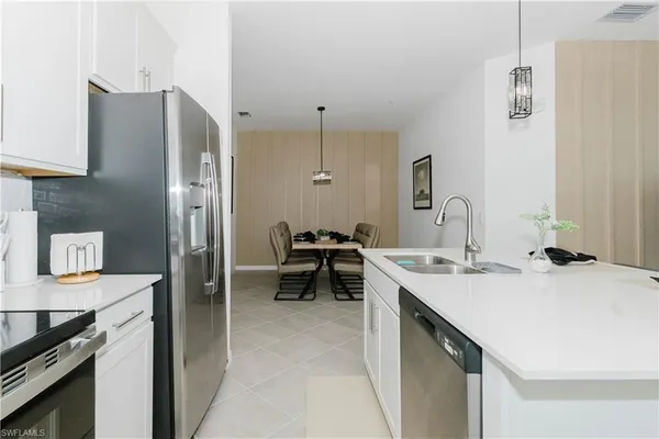 a kitchen with stainless steel appliances a sink stove and refrigerator