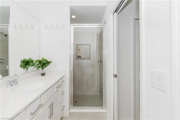 a bathroom with a shower sink and mirror
