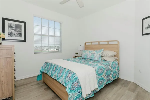 a bed sitting in a bedroom next to a window