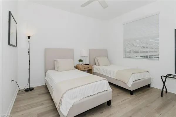 a bedroom with two beds and a couch