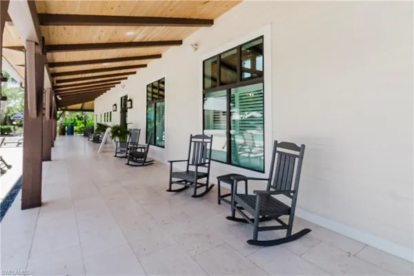 a view of a house with swimming pool and sitting area