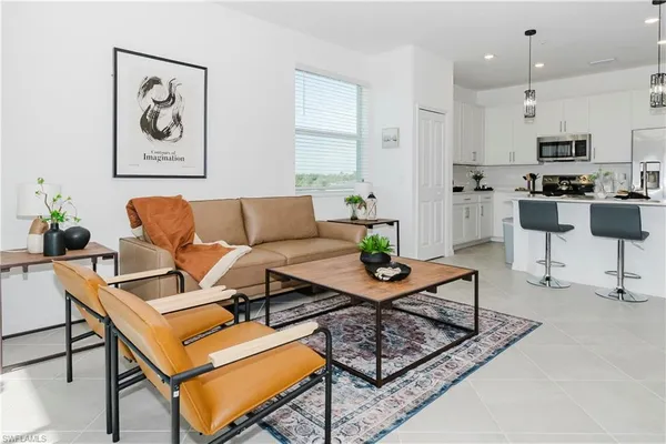 a living room with furniture and kitchen view