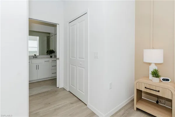 a view of a room that has a sink and a mirror in it