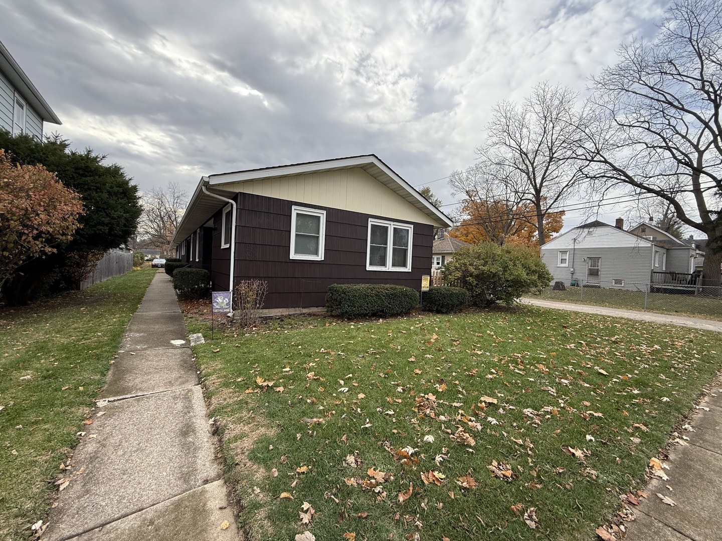 1060 West Hickory Street, Unit 1064 Kankakee, IL 60901 - Photo 1 of 6 a brick house with a big yard plants and large tree