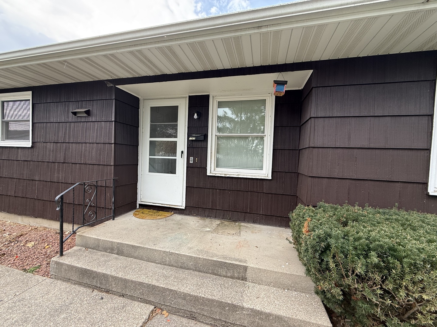 1060 West Hickory Street, Unit 1064 Kankakee, IL 60901 - Photo 2 of 6 a view of a house with a large window and wooden fence