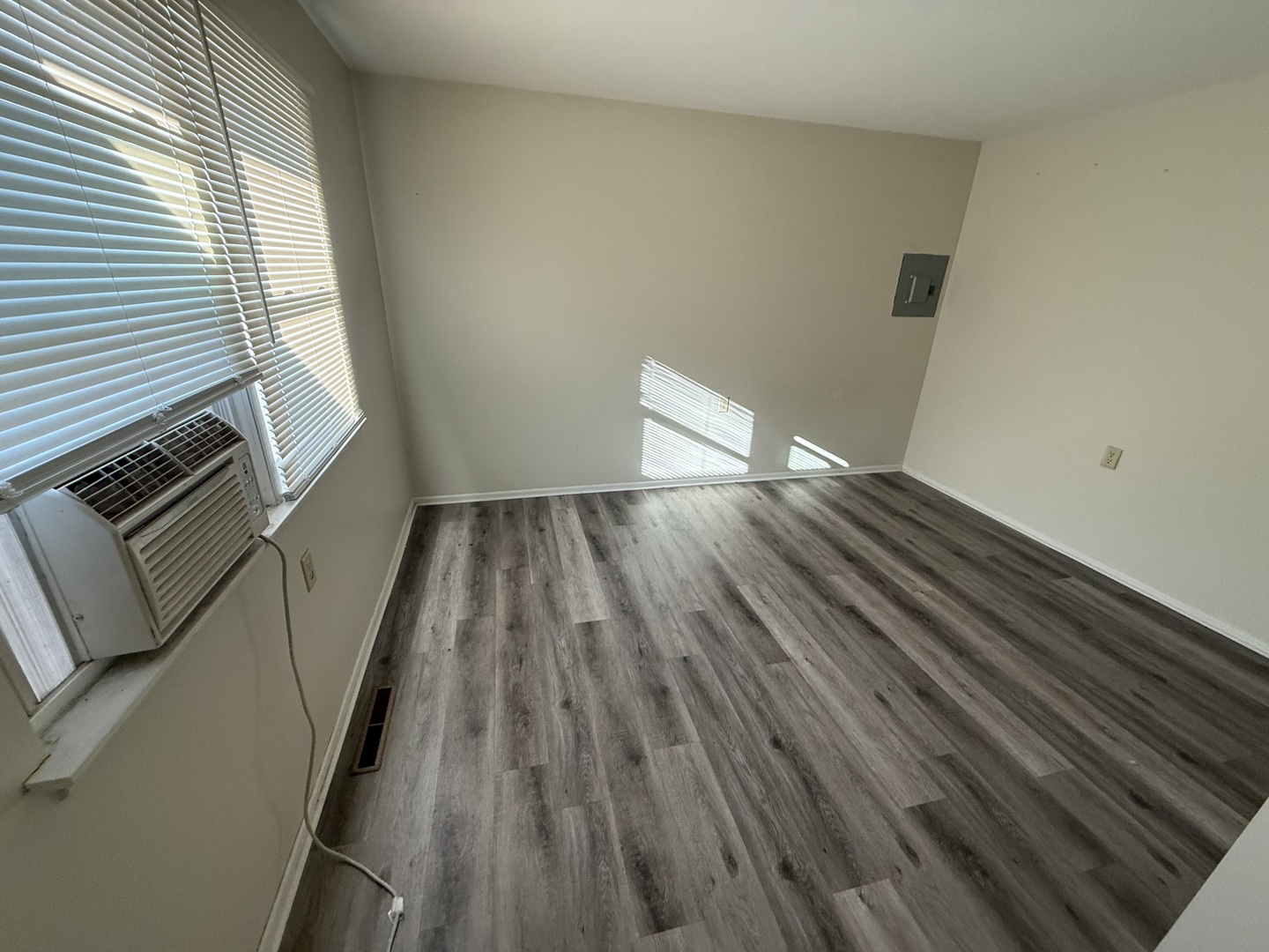 1060 West Hickory Street, Unit 1064 Kankakee, IL 60901 - Photo 4 of 6 a view of an empty room with wooden floor and a window