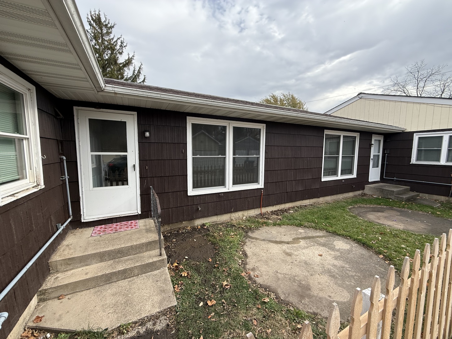 1060 West Hickory Street, Unit 1064 Kankakee, IL 60901 - Photo 6 of 6 a front view of a house with a garden