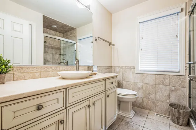 a bathroom with a sink a toilet and mirror