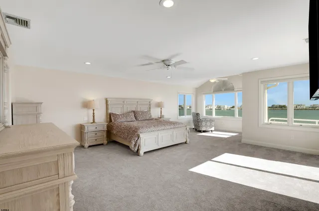 a spacious bedroom with a bed and window