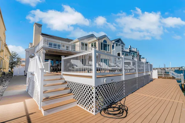 a view of a brick house with wooden fence