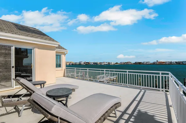 a roof deck with a table and chairs