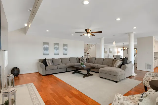 a living room with furniture and kitchen view