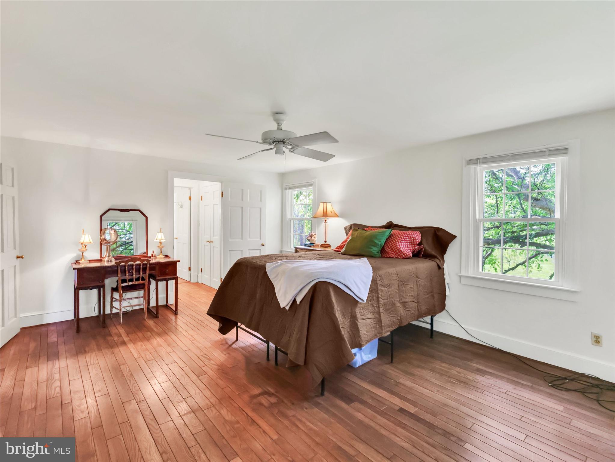 19255 Telegraph Springs Road Purcellville, VA 20132 - Photo 34 of 107 a bedroom with a bed a table and chair