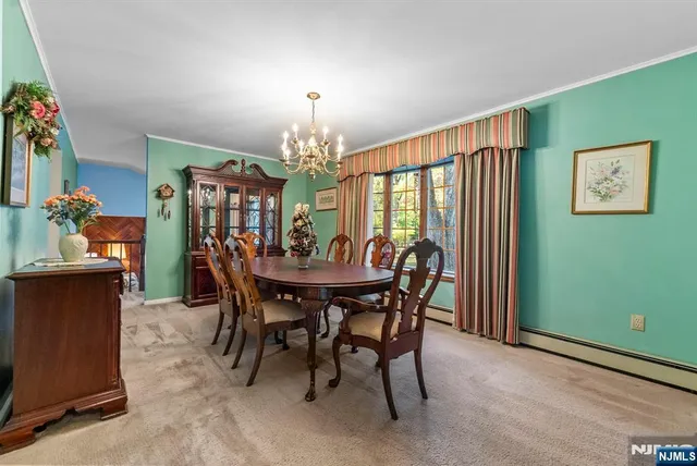 a view of a dining room with furniture and chandelier