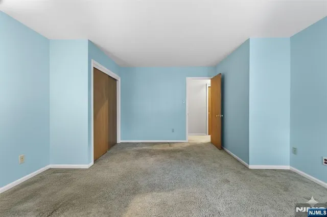 an empty room with closet and a bathroom