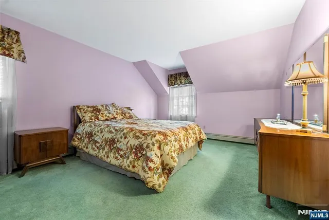 a bed sitting in a room next to a window