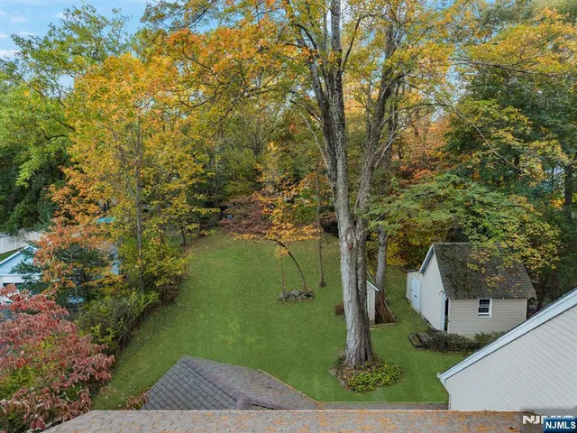 an aerial view of a residential houses with yard