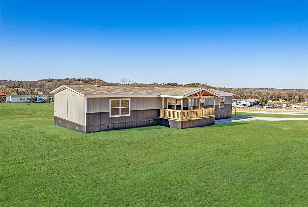 245 Lelon Lane Springtown, TX 76082 - Photo 2 of 37 a view of a house with a big yard