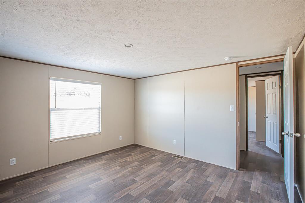 245 Lelon Lane Springtown, TX 76082 - Photo 26 of 37 a view of an empty room with wooden floor and a window