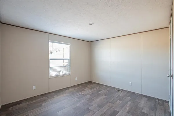 an empty room with windows and closet