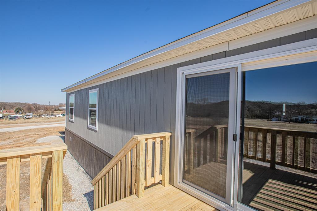 245 Lelon Lane Springtown, TX 76082 - Photo 35 of 37 a view of a balcony with wooden floor and fence
