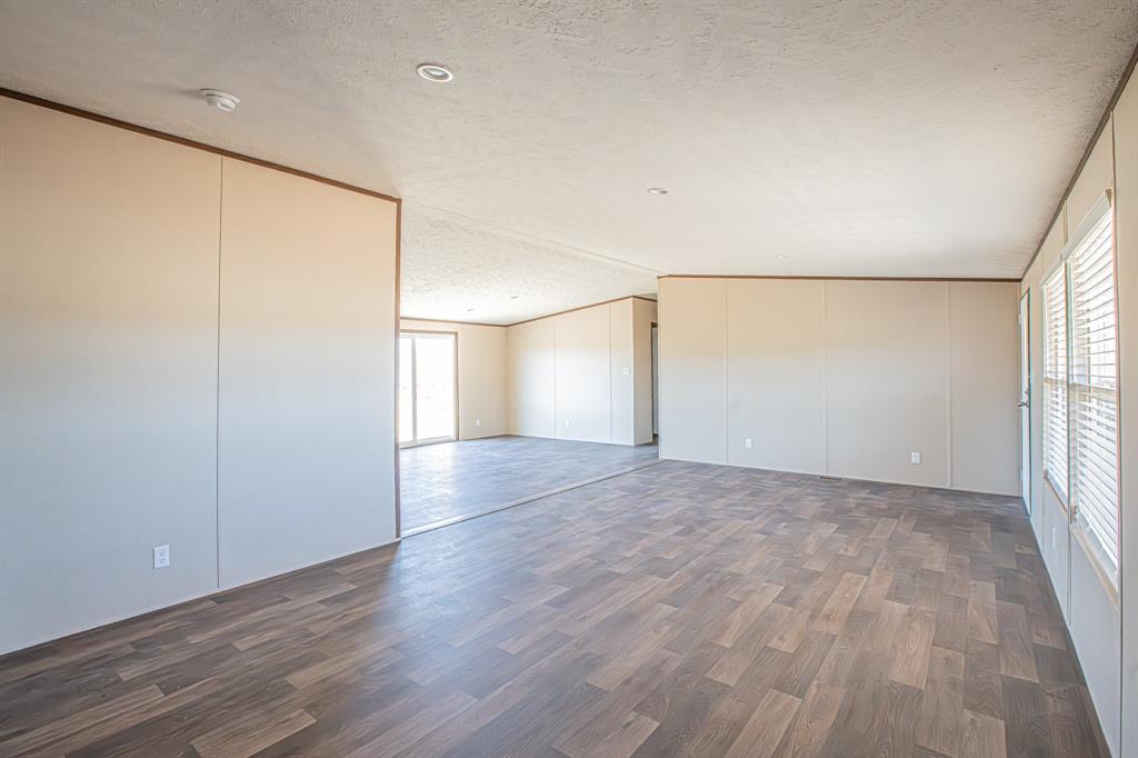 245 Lelon Lane Springtown, TX 76082 - Photo 5 of 37 an empty room with wooden floor and windows